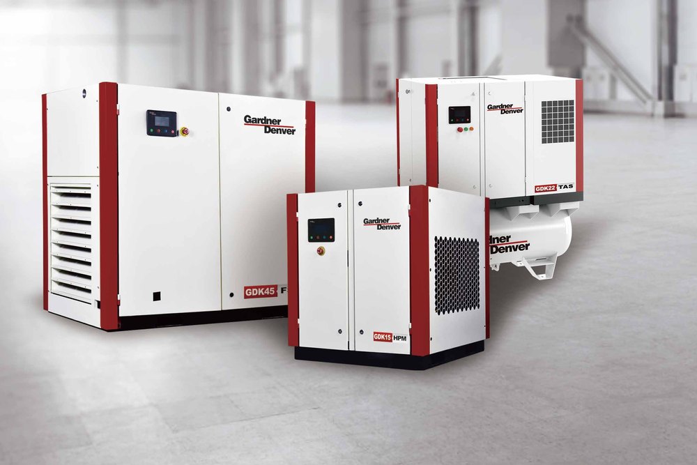 Three Gardner Denver oil-flooded screw air compressors installed in a plant hall