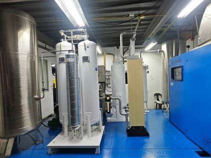 The same room after installation — PSA nitrogen generator, buffer vessel and dryer piped in