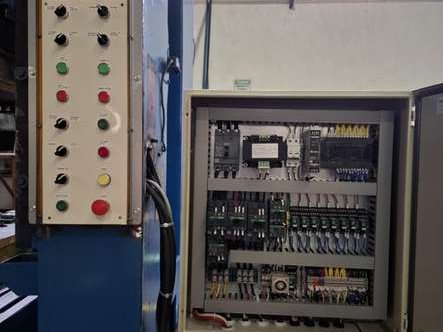 The same machine after rehabilitation — new pilot devices and a rebuilt control panel